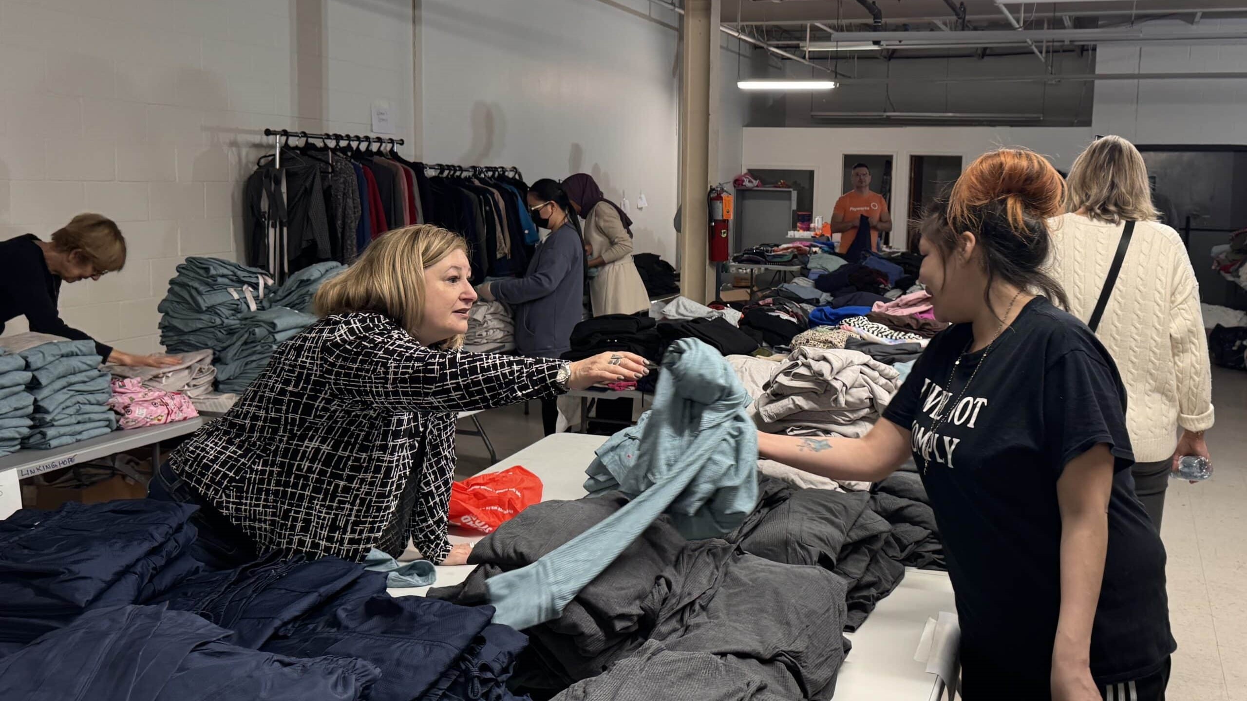 Volunteers sorting donated clothing at Linking Hope’s Winnipeg warehouse