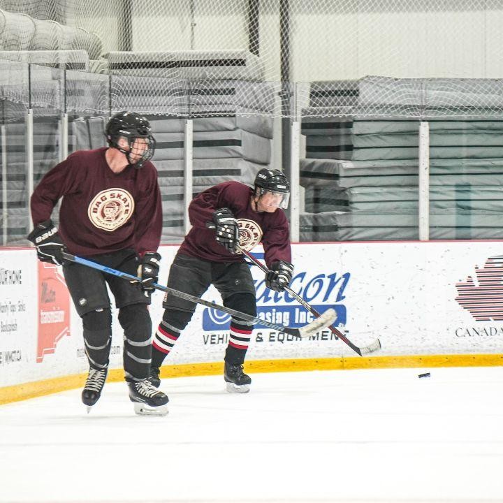 image of two hockey players wearing bag skate hockey club jerseys on the ice